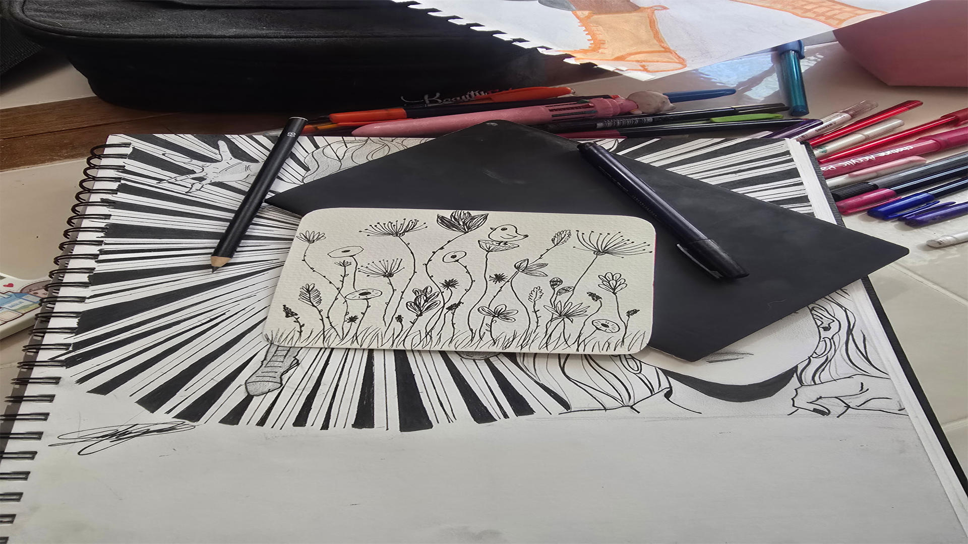 Polendo Design sketchbook with hand-drawn floral artwork and pens showing the creative design process