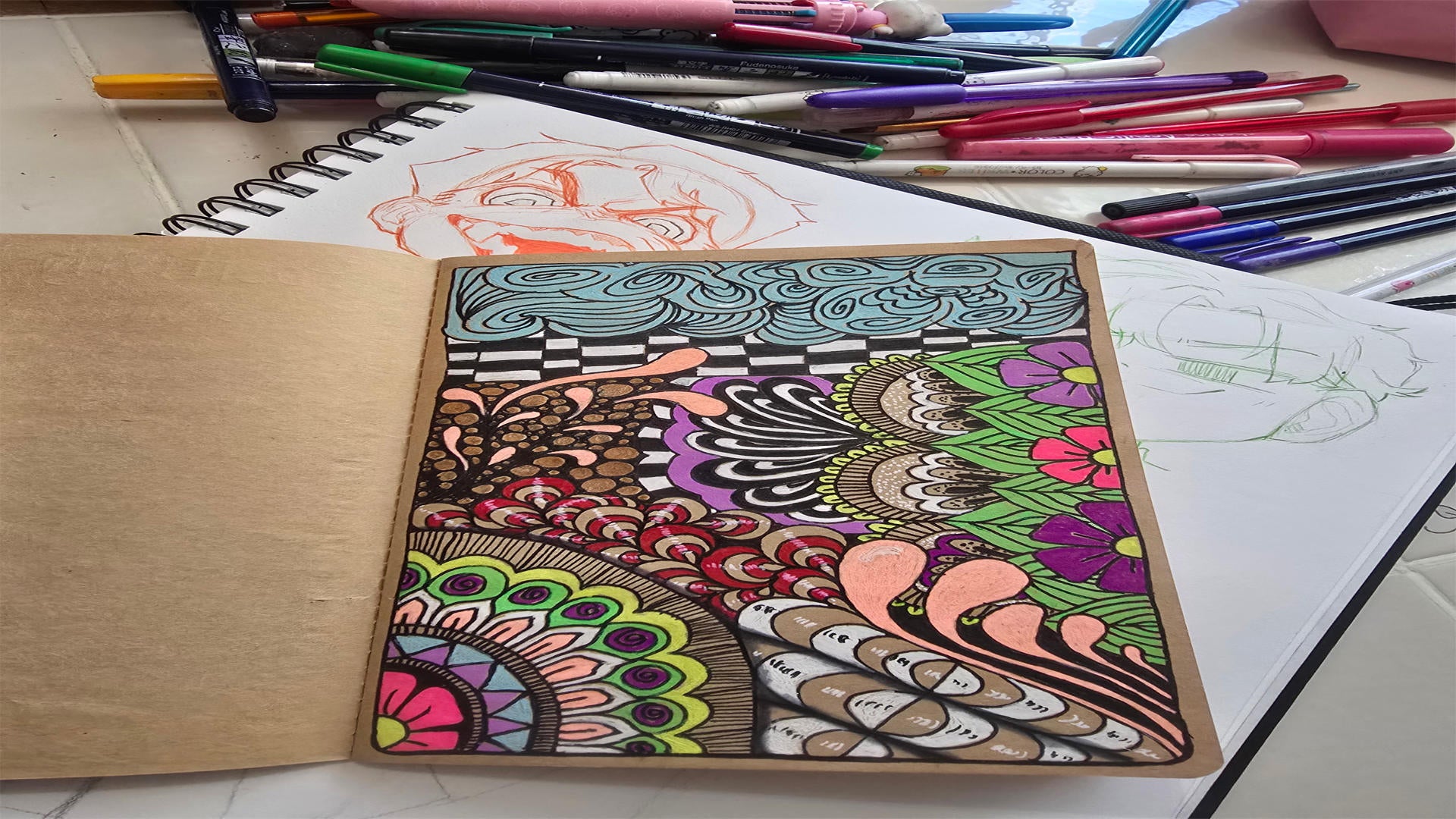 Polendo Design sketchbook artwork with markers showing original hand-drawn designs transformed into vibrant creations